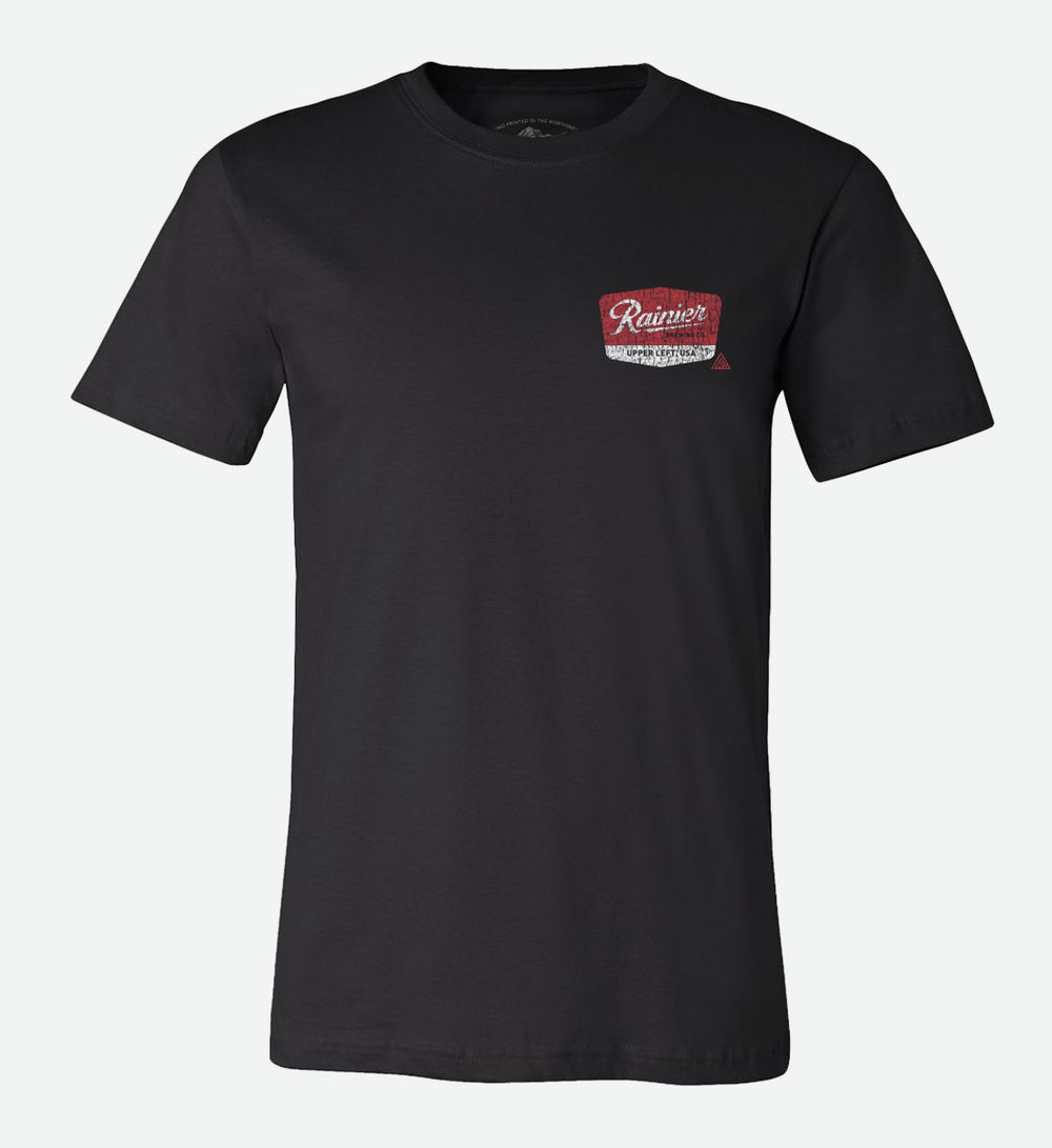Back of a black t-shirt by The Great PNW featuring a distressed red and white vintage graphic that reads "Rainier Brewing Co." and "Upper Left, USA" with the text "Brewed for the Great Pacific Northwest" below it.