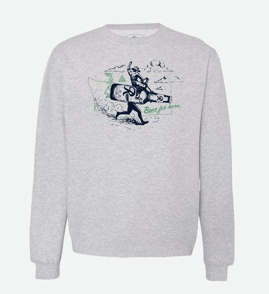 Heather grey crewneck sweatshirt by The Great PNW featuring a vintage graphic of a cowboy riding a giant running Rainier Beer bottle. The design includes a light green outline of Washington state in the background and the text "Beer for here." written in green cursive.
