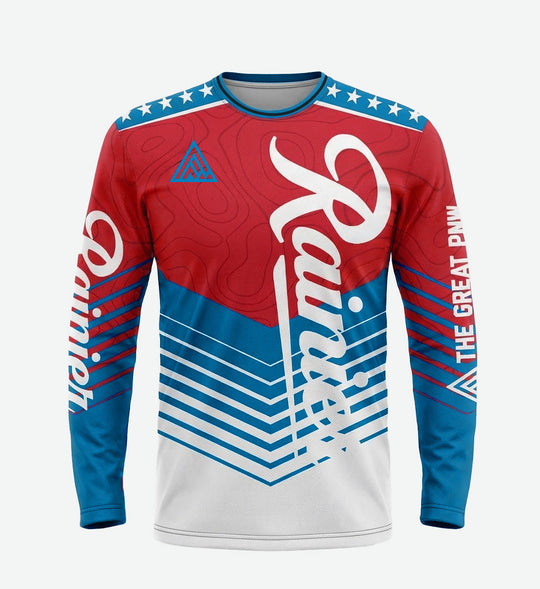 Long-sleeve bike jersey by The Great PNW featuring a bold red, white, and blue chevron and topographical map design. The classic Rainier Beer script logo runs vertically down the front, with stars on the shoulders and "The Great PNW" text printed on the left sleeve.