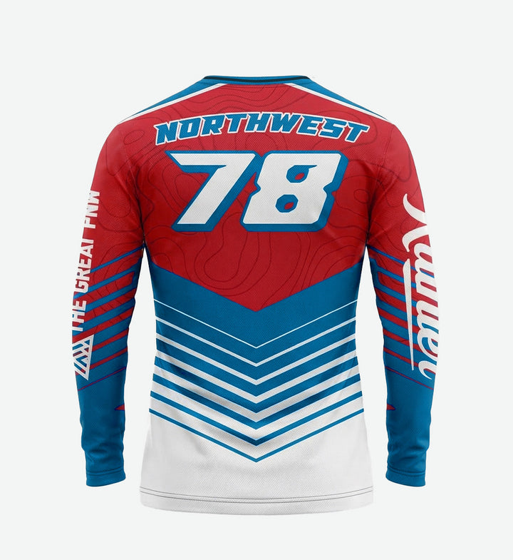 Long-sleeve bike jersey by The Great PNW featuring a bold red, white, and blue chevron and topographical map design. The classic Rainier Beer script logo runs vertically down the front, with stars on the shoulders and "The Great PNW" text printed on the left sleeve.